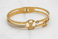 LOUIS VUITTON (LV) HAND CUFF, GOLD PLATED WITH AMERICAN DIAMOND