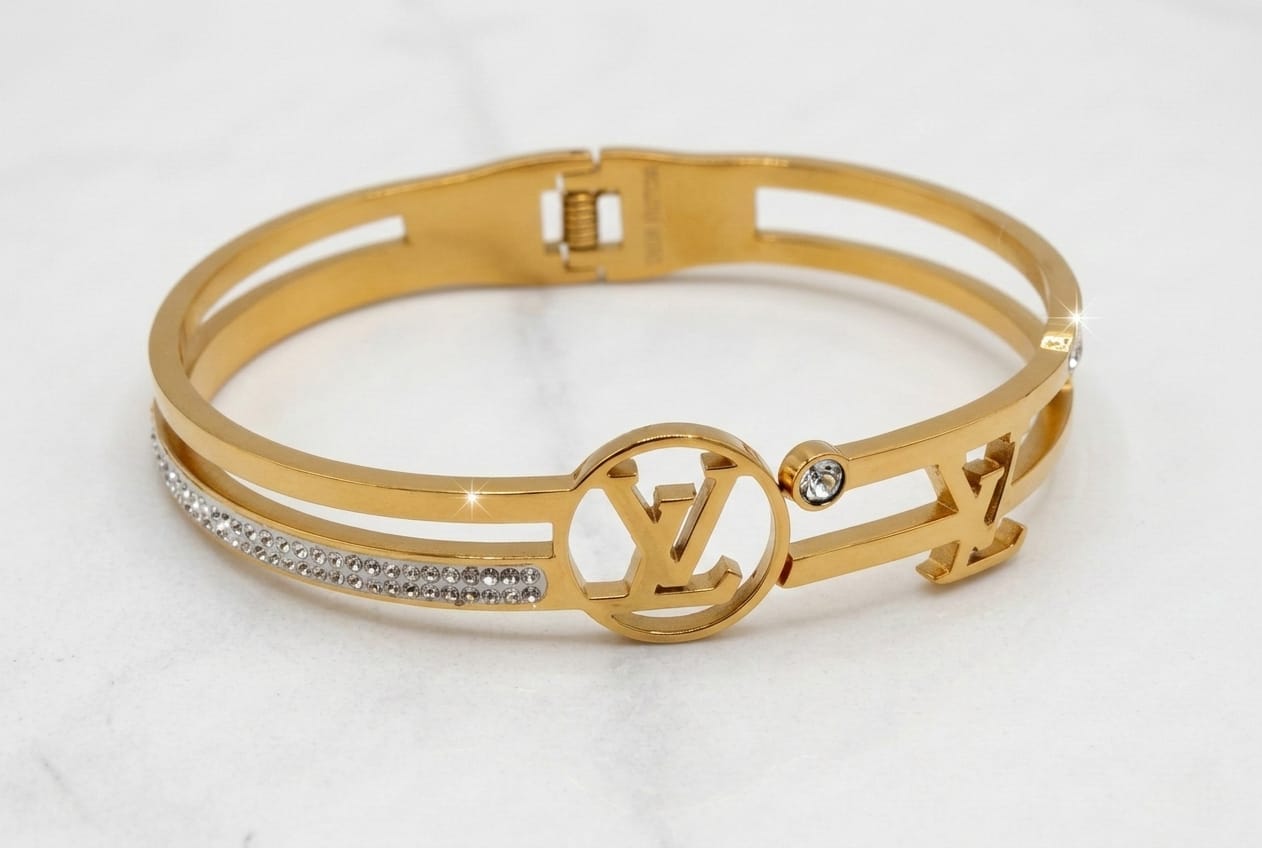 LOUIS VUITTON (LV) HAND CUFF, GOLD PLATED WITH AMERICAN DIAMOND